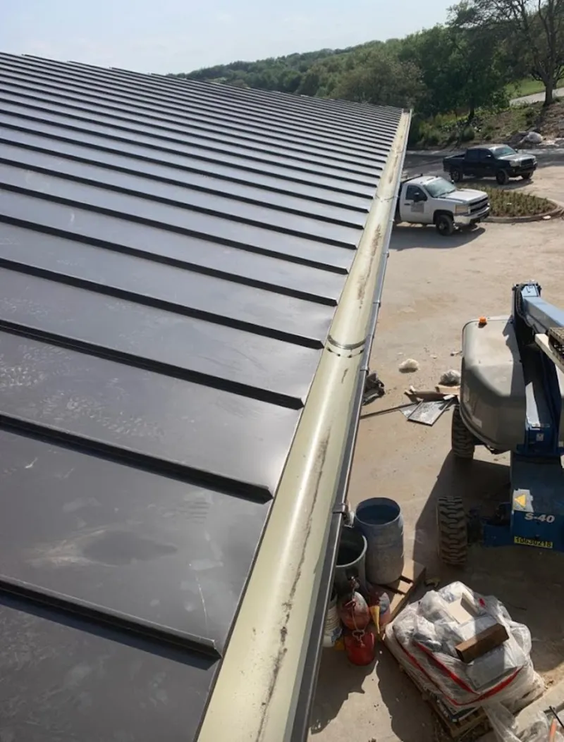 Standing seam panel and gutter detail on a metal roofing jobsite in Quincy